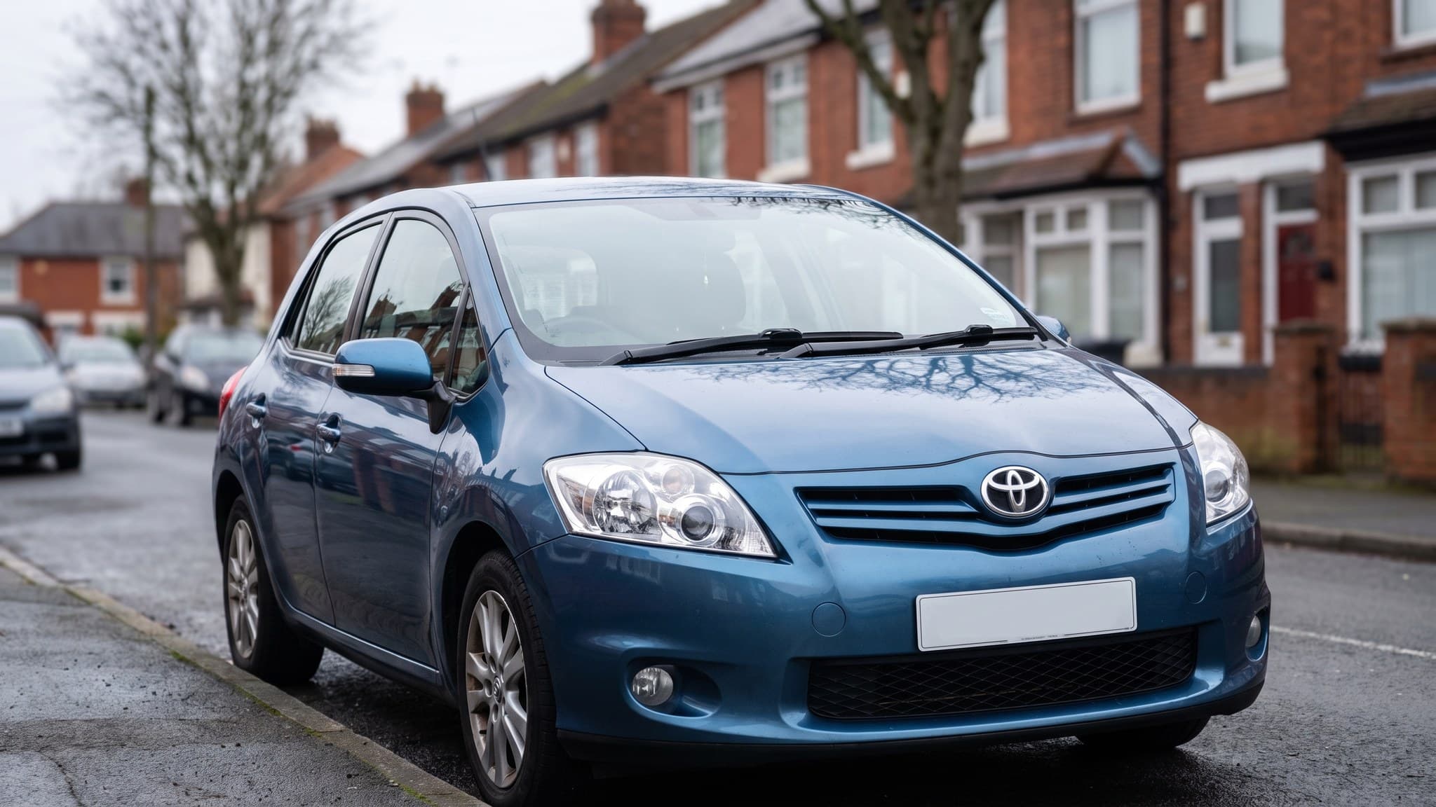 A blue Toyota Auris hybrid on a UK residential street