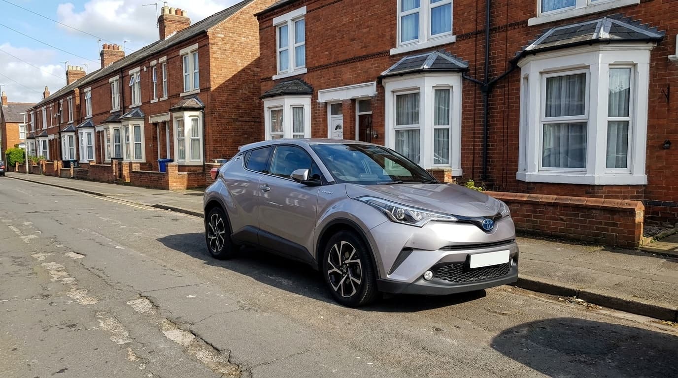 A silver Toyota C-HR parked on a terraced UK street